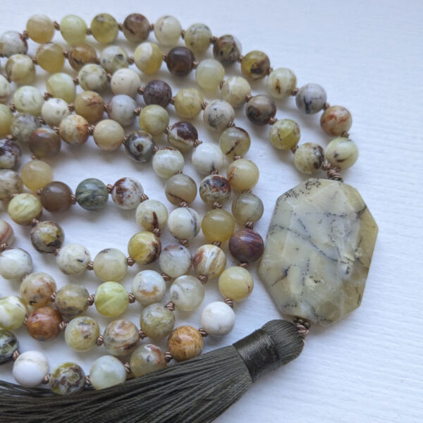 Kollased ja kirjukad ümmargused kristallid pärlid. Kollane Opaal kristall Guru ehk õpetaja kivi. 108 pärliga spirituaalne Mala palvehelmed kaelakee. samblaroheline tutt. Heledal taustal